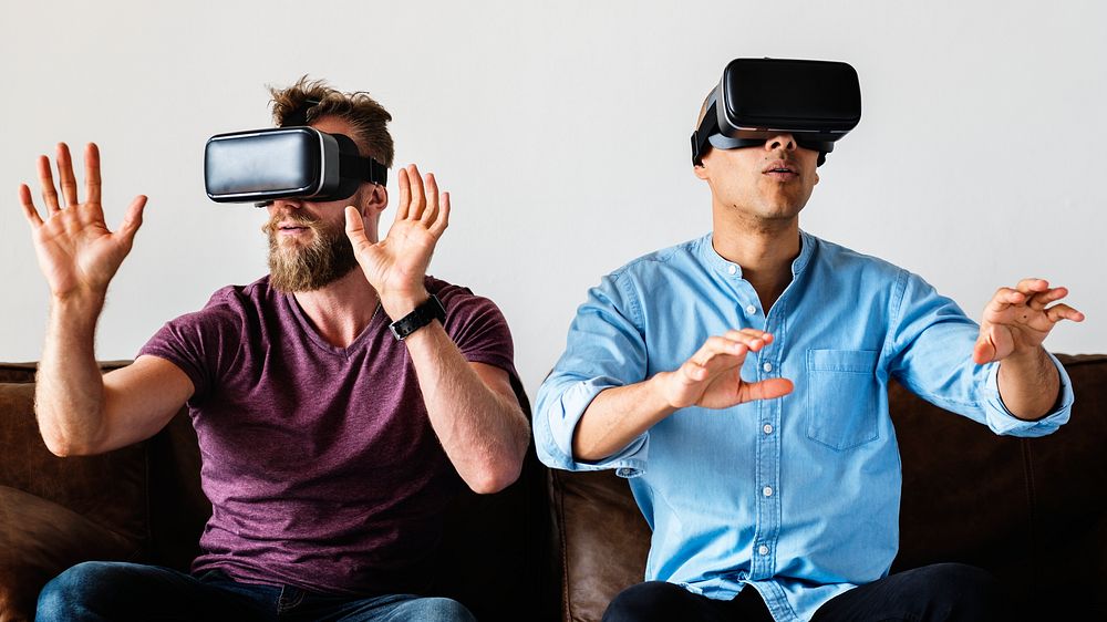 Men enjoying VR on a couch