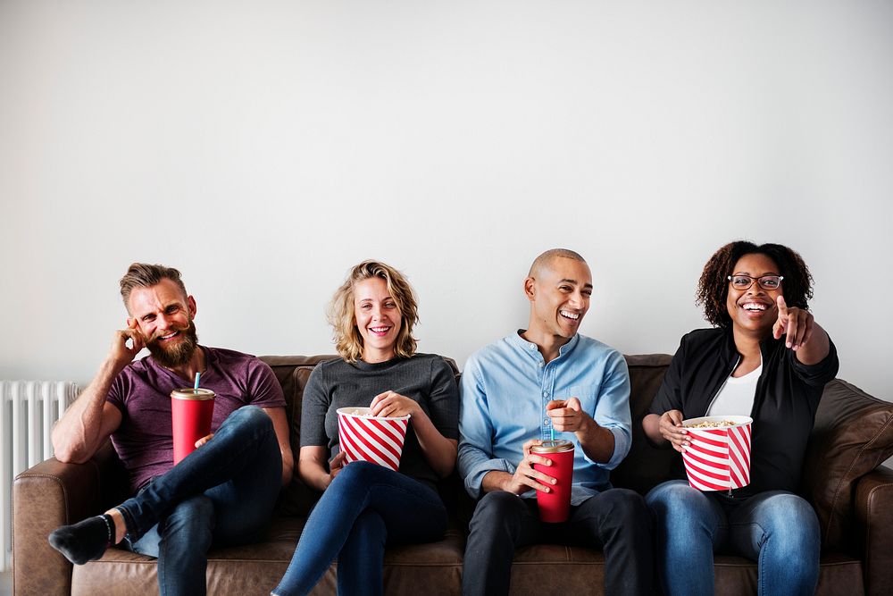 Group of friends having a great time watching movie