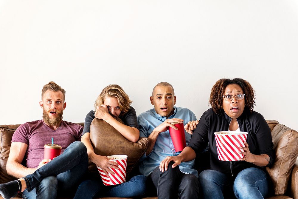 Group of friends terrified watching thriller movie