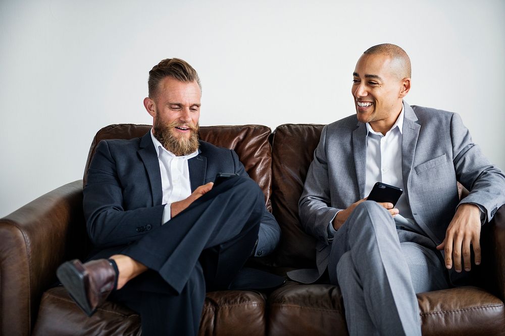 Two businessman sitting on a couch