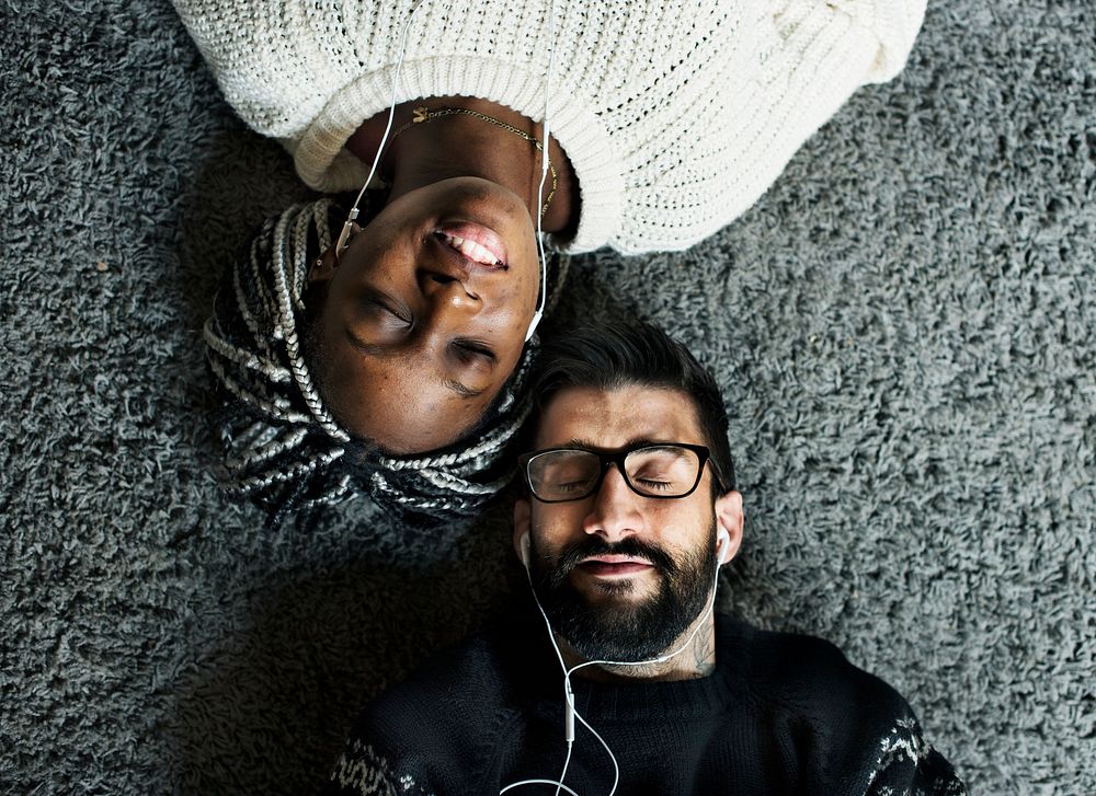 Couple listening to music together on a floor