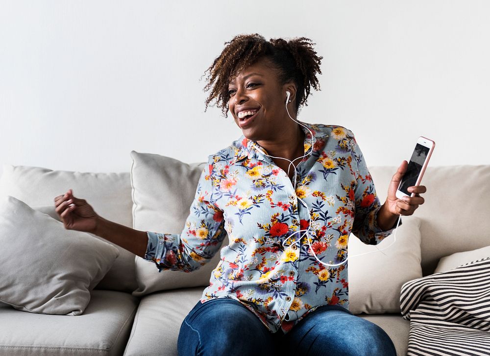 African American woman enjoying music at home leisure and music concept
