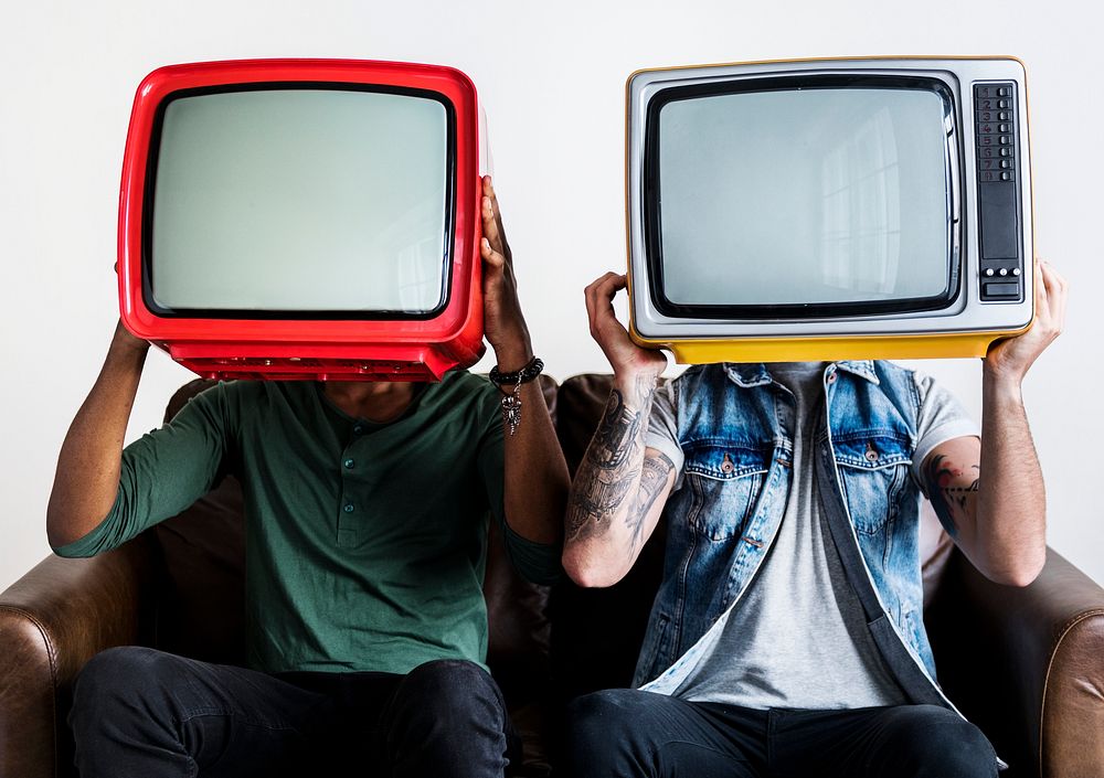 People holding retro television next to each other