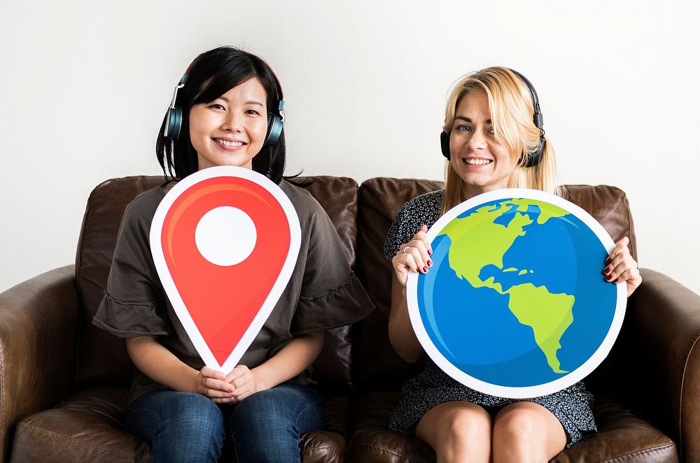 Two woman holding location icon