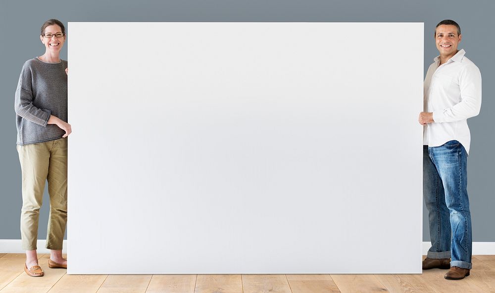 Man and woman holding blank board