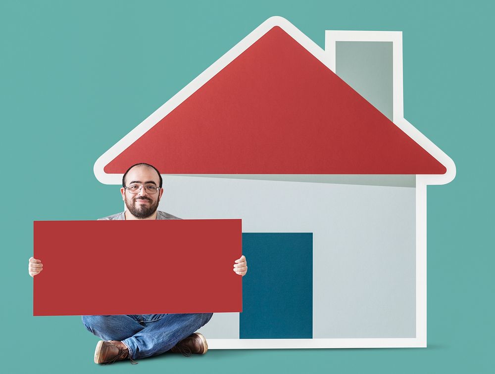 Man holding poster with house mockup