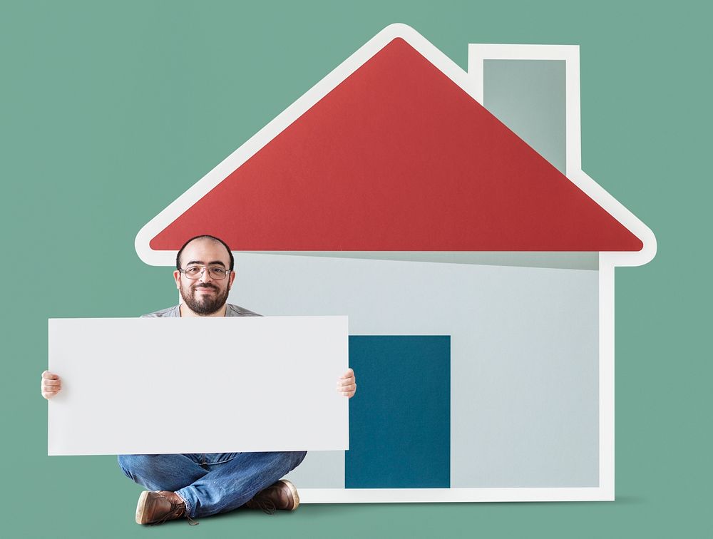 Man holding poster with house mockup