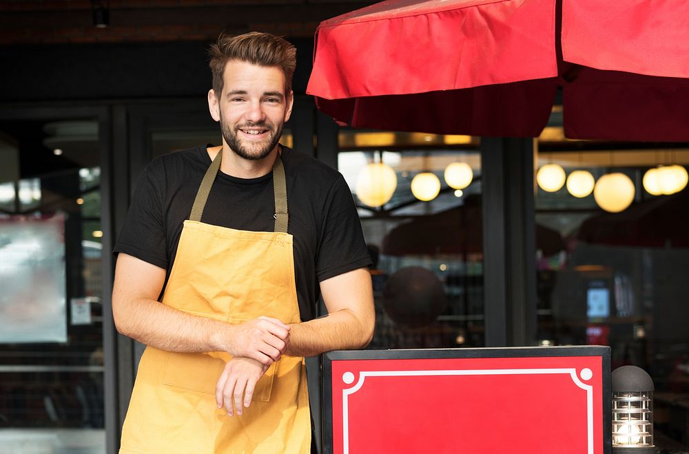 Small business owner standing infront of restaurant