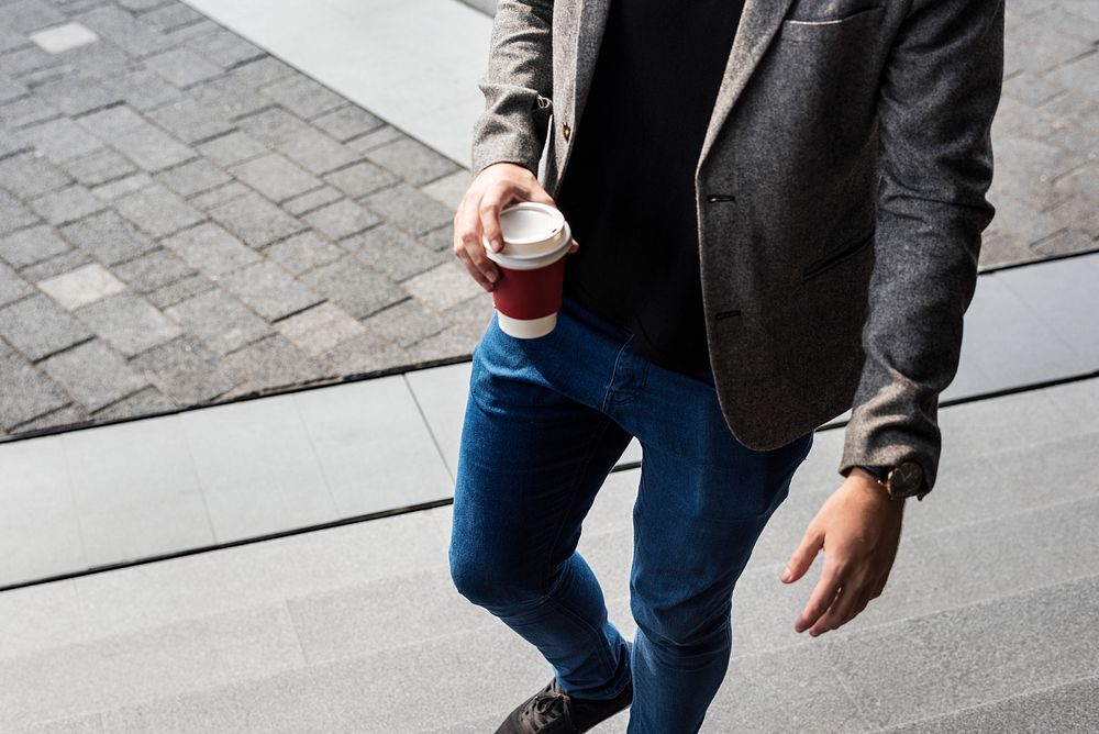 Person holding hot coffee cup