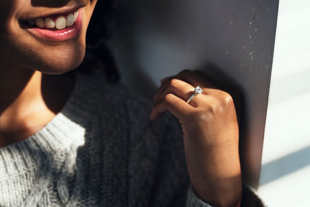 Cheerful woman with engagement ring