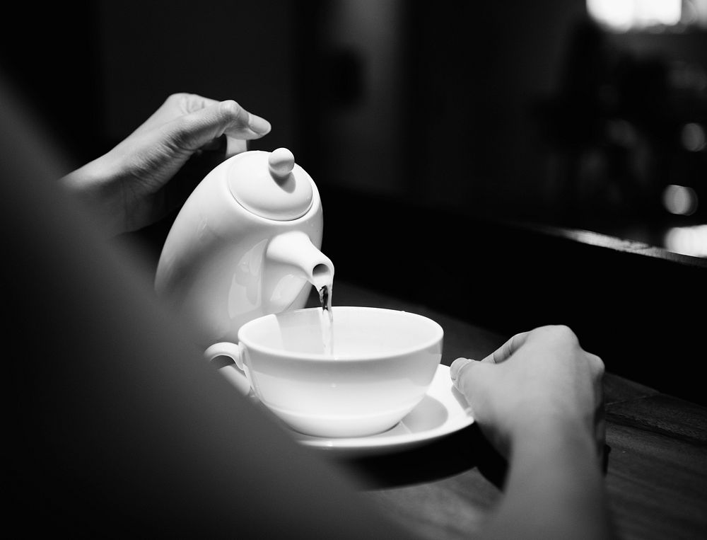 Woman holding a pot and pouring a drink