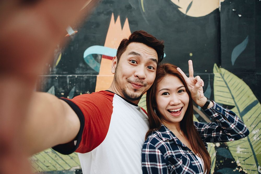 Happy couple taking selfie together
