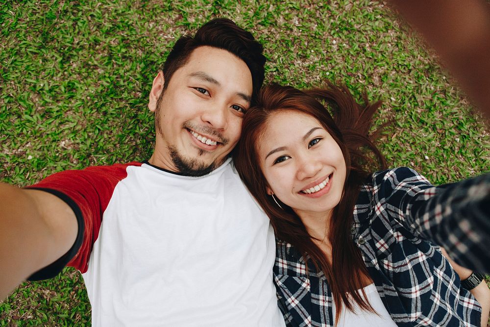 Couple taking a selfie in the grass