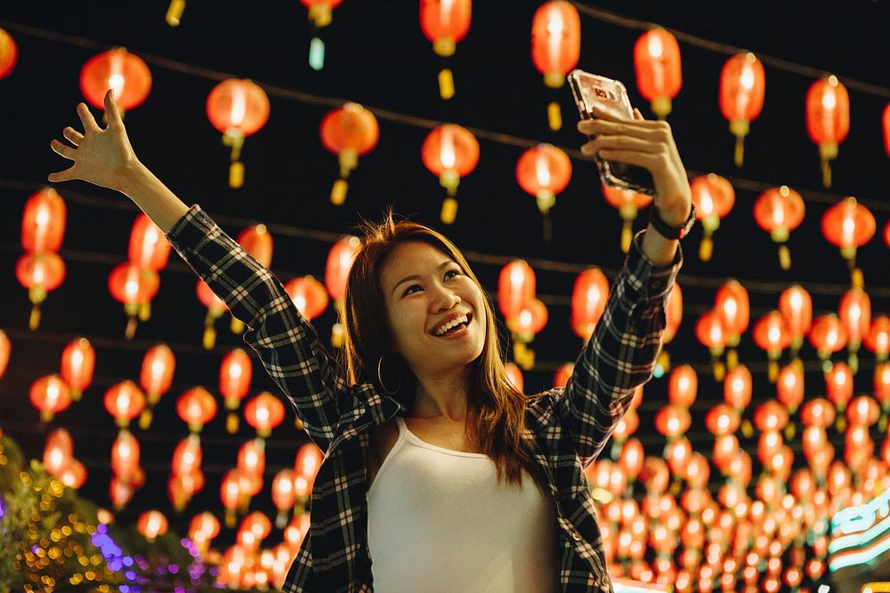 Woman taking selfie at lantern festival