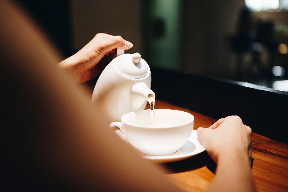 Woman pouring a hot drink