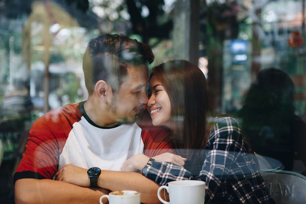 Lovely asian couple having coffee