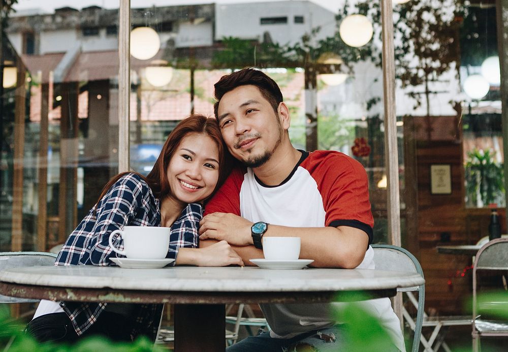 Lovely asian couple having coffee