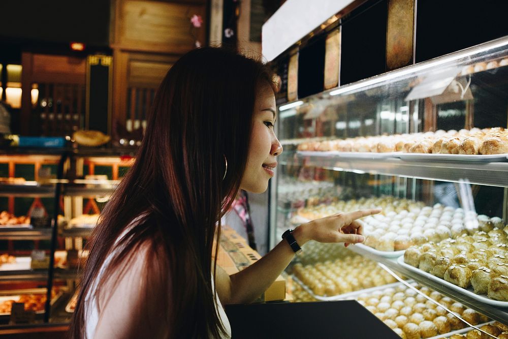 Asian girl pointing at Chinese pastries