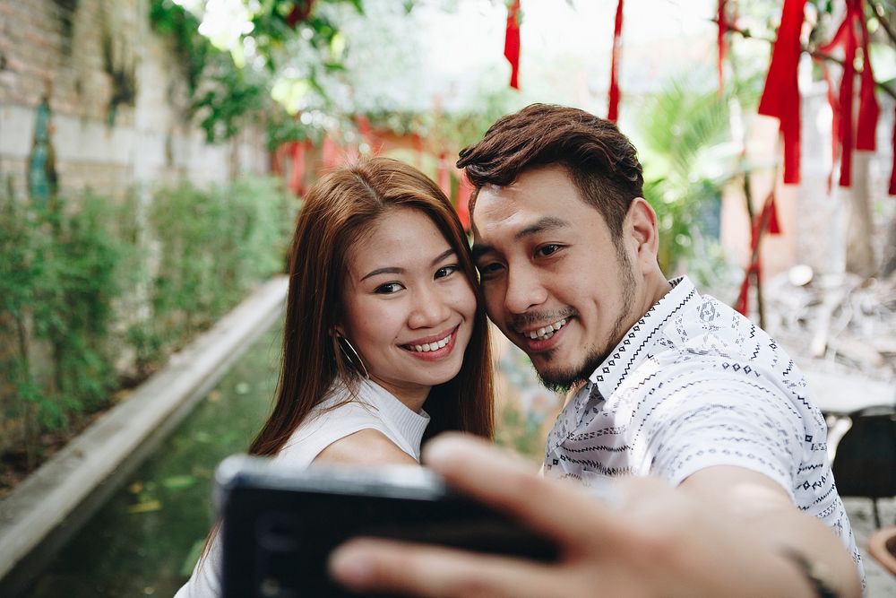 Happy couple taking selfie together