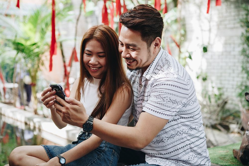 Young couple using a phone together