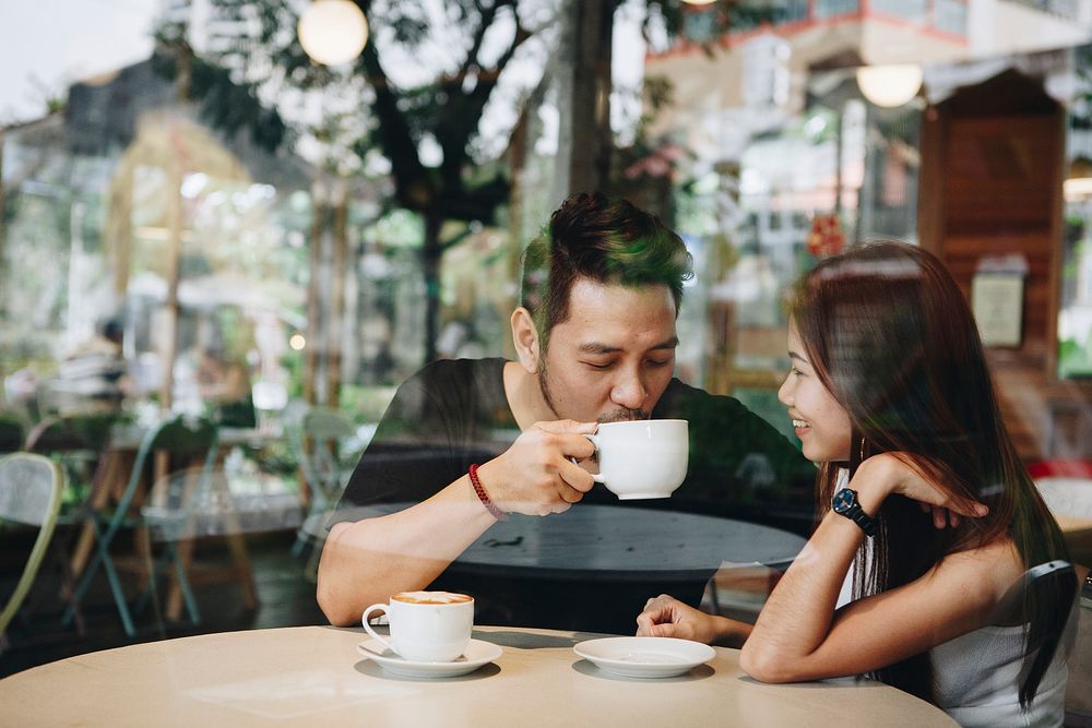 Lovely asian couple having coffee