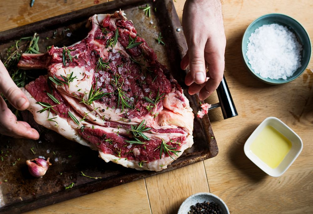 A chef preparing steak on a cutting board food photography recipe idea