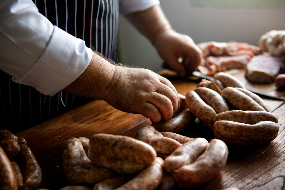Butcher with smoked sausages on a string | Premium Photo - rawpixel