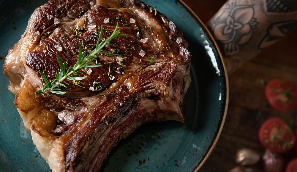Tomahawk on a plate with garnish food photography recipe idea