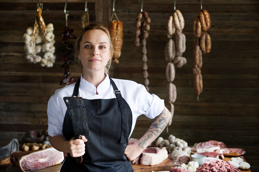 Female butcher selling meat in a butcher shop food photography recipe idea