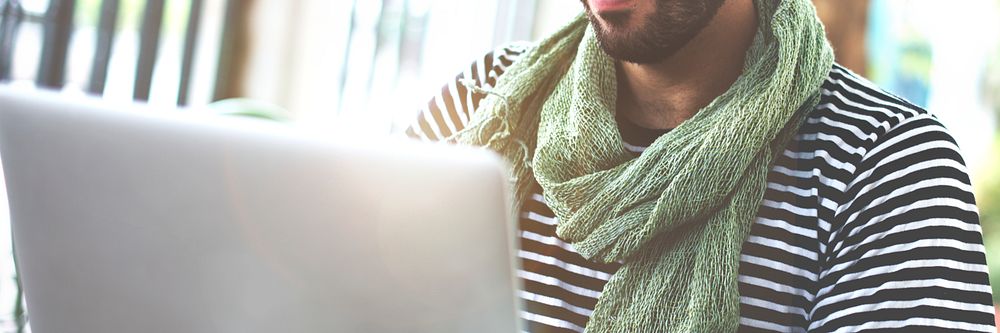 Guy wearing a scarf on his laptop