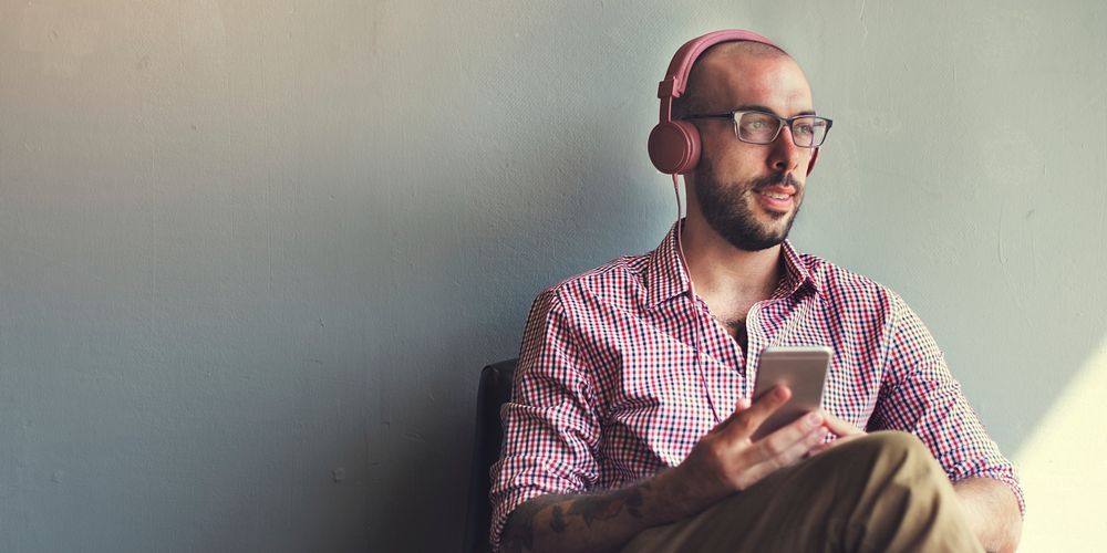 Bearded guy sitting alone listening to music