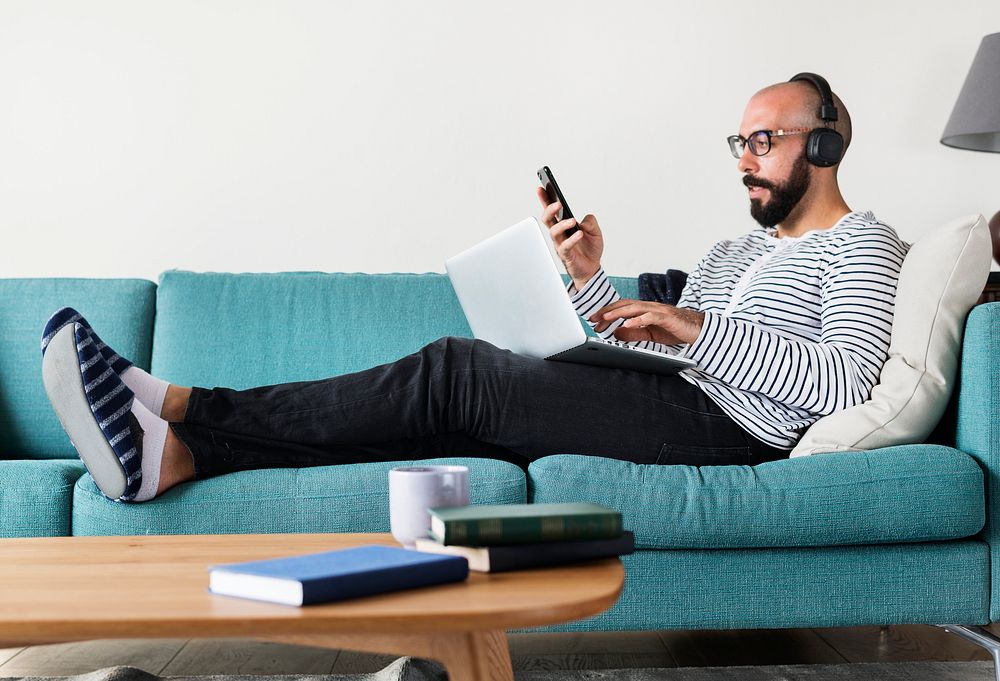 Man using device on couch