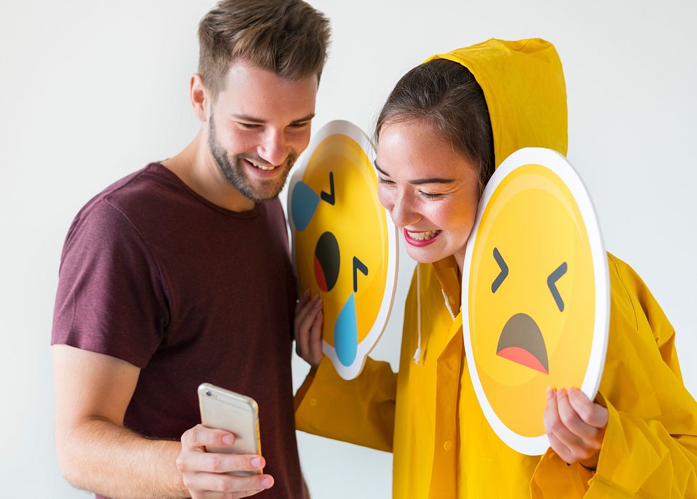Couple taking selfie with emojis