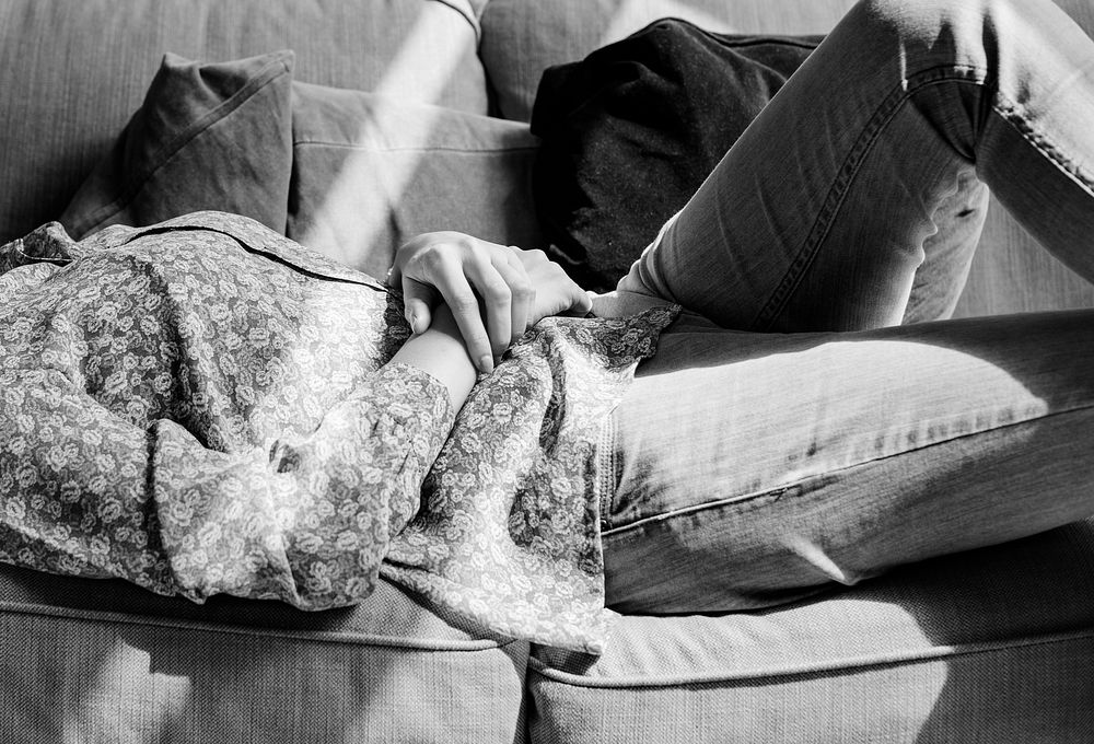 Woman lying on the couch grayscale