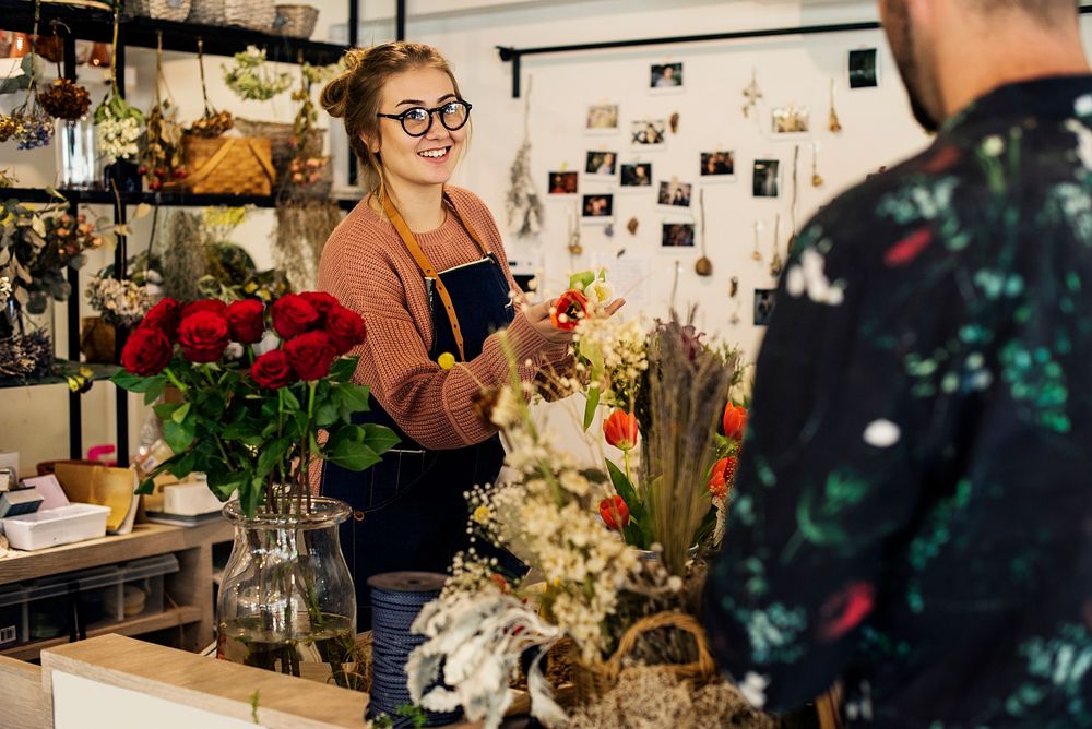 Florist suggesting flower bouquet to customer