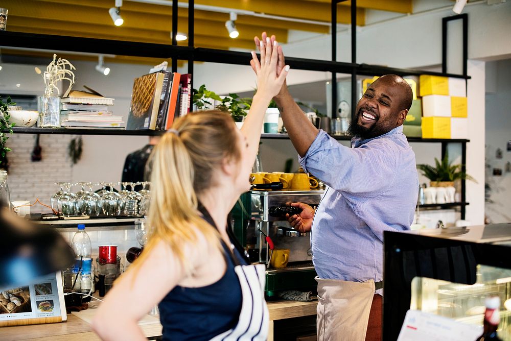 Colleagues give a high five to each other