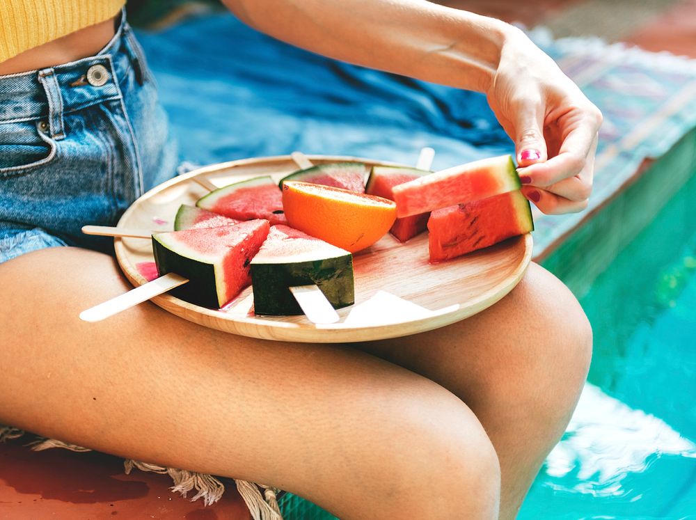 Caucasian woman eating watermelon in summertime