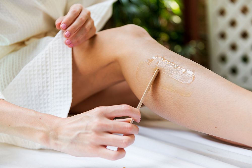Woman getting legs waxed at a spa