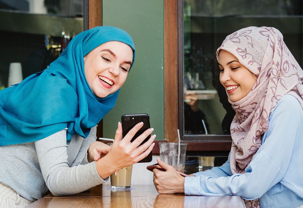 Muslim women talking and looking on the smart phone