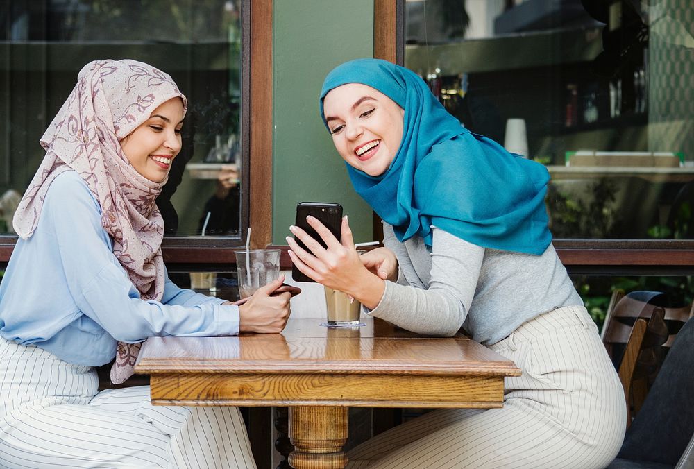 Muslim women talking and looking on the smart phone
