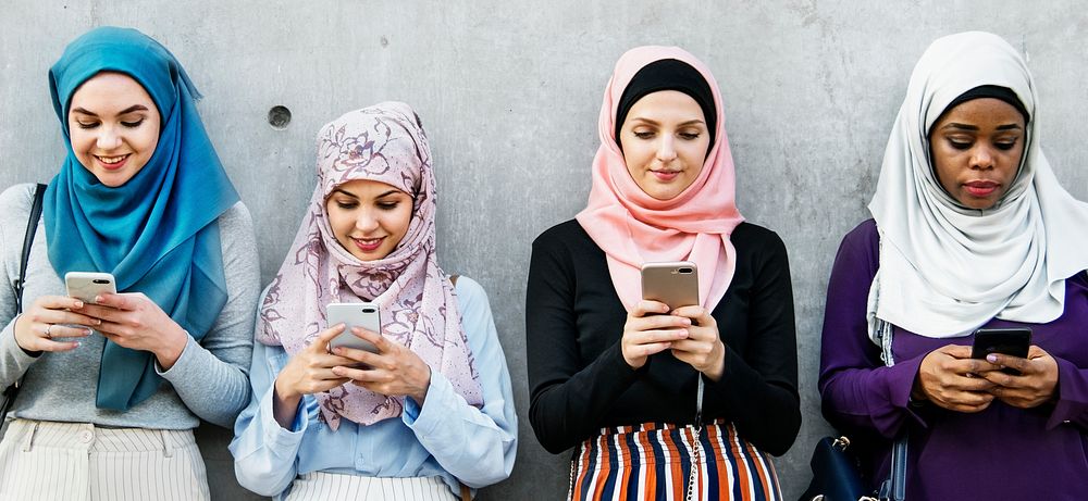 Muslim girls texting on the phone