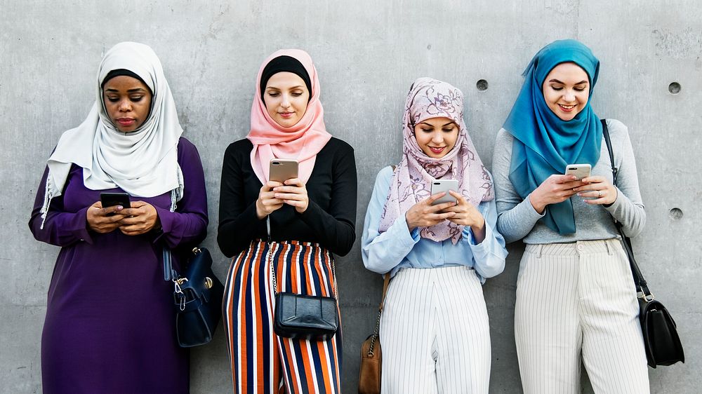 Muslim girls texting on the phones