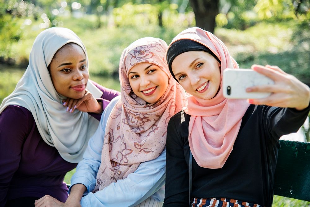 Muslim women taking selfie together