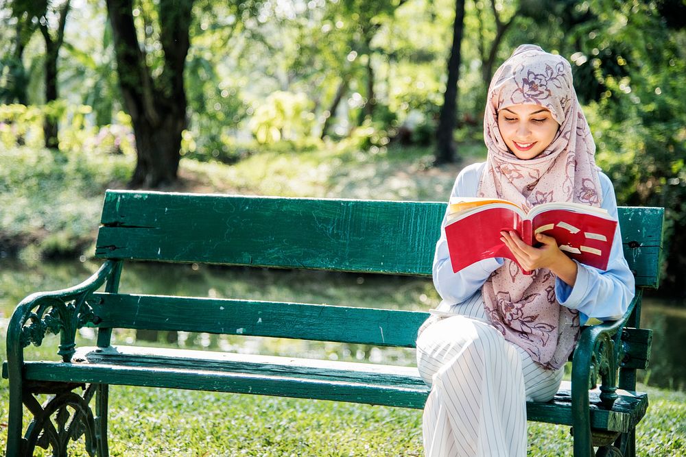 Islamic woman reading the book at the park