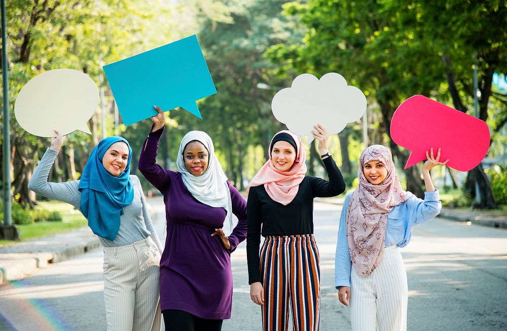 Muslim women holding blankspeech bubbles