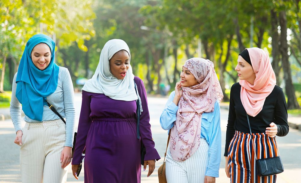 Islamic women friends walking and discussing together