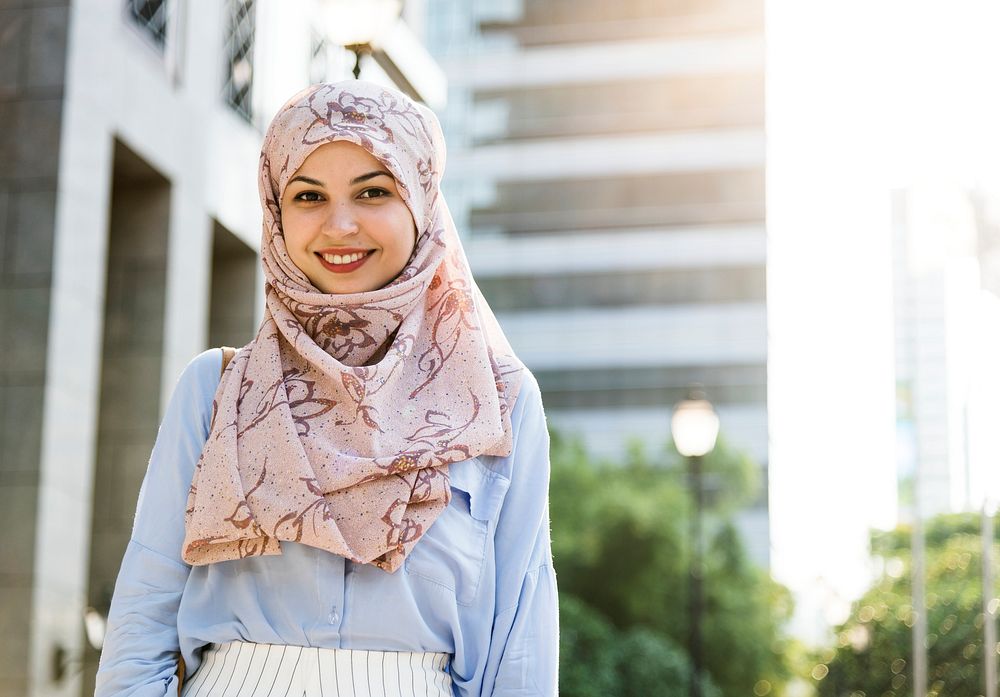 Islamic woman standing and smiling  in the city