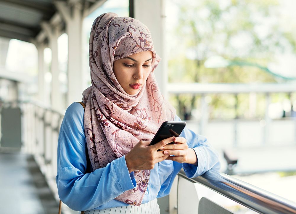 Islamic woman texting messaging on the phone
