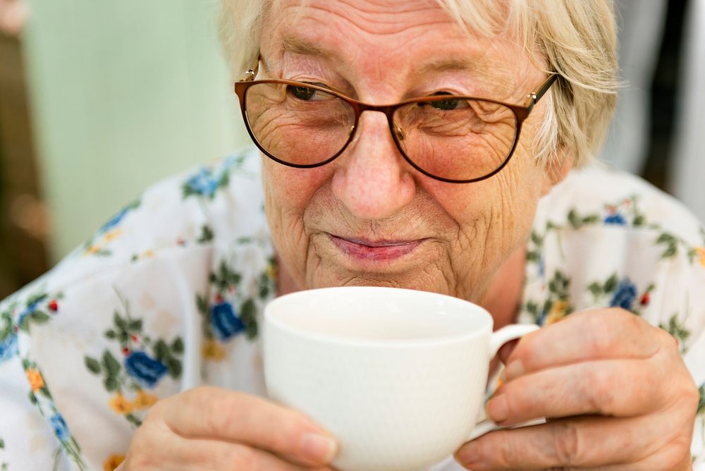 Elderly woman having afternoon tea on the veranda