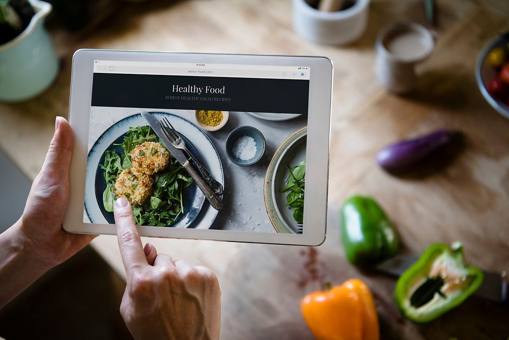 Woman pointing at a screen with heathy foods